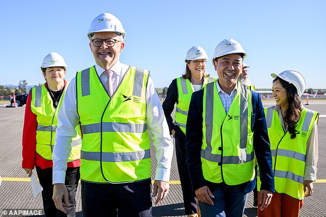 Prime Minister Anthony Albanese (centre) has been criticised for a key part of his promise regarding Australia's newest, and still unbuilt, international airport