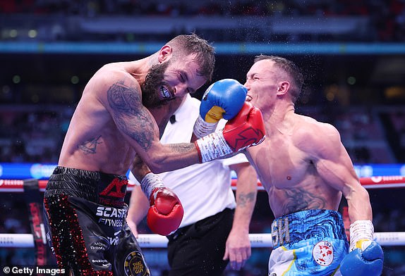 LONDON, ENGLAND - SEPTEMBER 21: Anthony Cacace and Josh Warrington exchange punches during the IBO World Super Featherweight Title fight between Anthony Cacace and Josh Warrington, on the Riyadh Season - Wembley Edition card at Wembley Stadium on September 21, 2024 in London, England. (Photo by Richard Pelham/Getty Images)