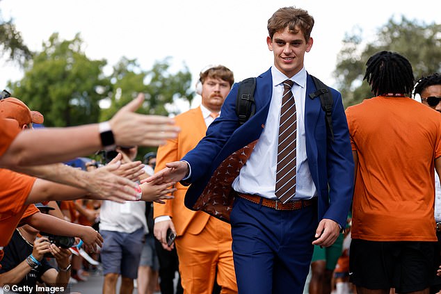 Texas Longhorns' Arch Manning greets fans on their way into the stadium on Saturday