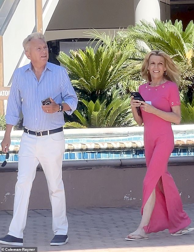 White, 67, looked stunning in a pink dress and silver sandals, while Sajak, 77, wore a casual blue shirt, chinos and sneakers.