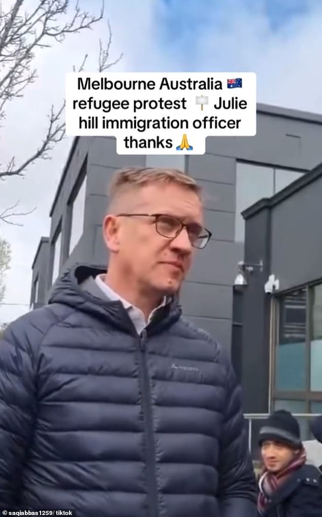 Labor MP Julian Hill is pictured speaking to protesters outside his Dandenong office