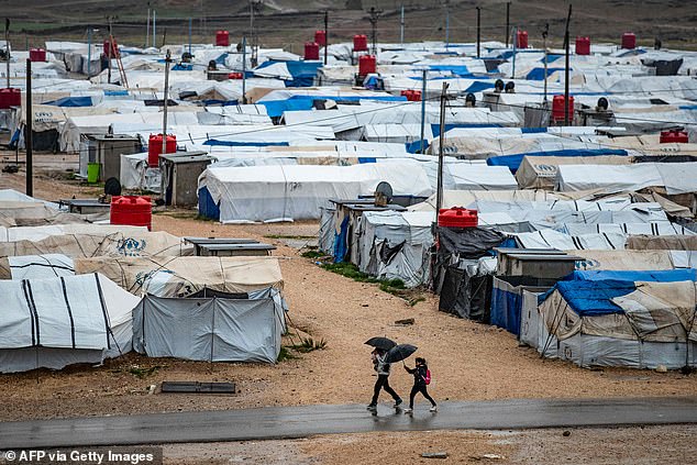 The camp, located near the Iraqi border, consists of dozens of tents pitched on a dirt and gravel field surrounded by a metal fence.