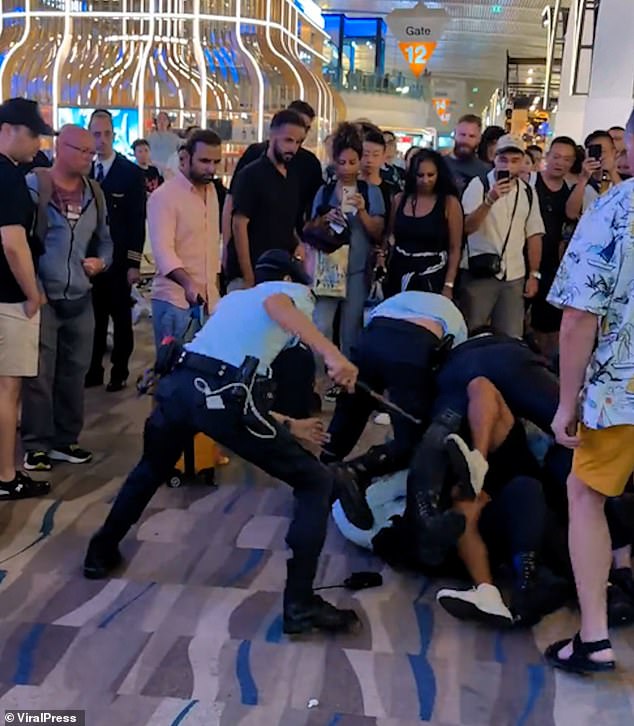 An Australian traveler was wrestled to the floor of a Thai airport after he started acting out while being locked out of a bar