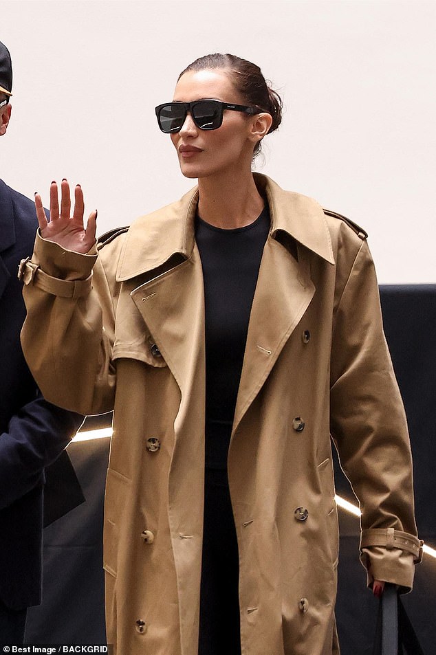 Bella Hadid, 27, looked stylish in a brown trench coat as she touched down for the start of Paris Fashion Week on Sunday