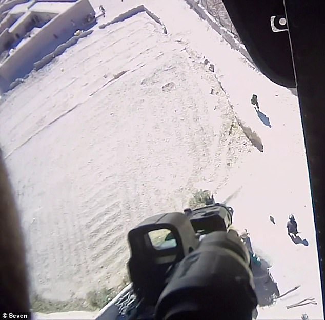 A warning shot is seen about to be fired from a military helicopter in Afghanistan