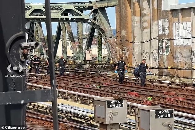 An 11-year-old boy died Monday around 10:15 a.m. after surfing onto the roof of a G train in Park Slope, Brooklyn. (Photo: Officers retrieve a backpack from the tracks)