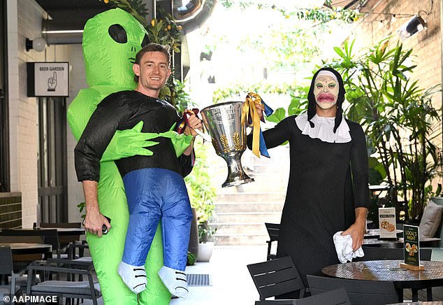 Harris Andrews (left) and Cam Rayner arrived at the pub in crazy outfits with the AFL Premiership Cup