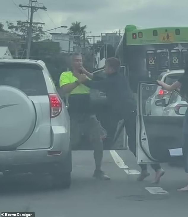 Two motorists were seen striking each other at the intersection of Bundall Road and Slatyer Avenue on the Gold Coast just before 8am on Thursday (pictured)