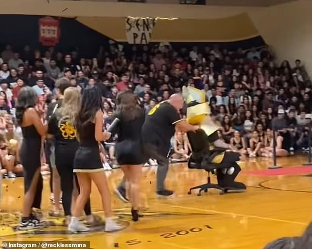 Nunes can be seen pushing the mascot out of the school gym