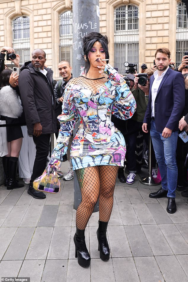 Cardi B puffed on a cigarette as she arrived at Vivienne Westwood's Paris Fashion Week show on Saturday