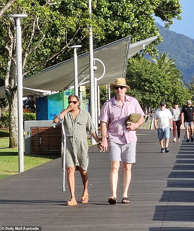 Cathy Freeman held hands with a mystery man during an intimate stroll along the coast in Cairns, less than a month after she and her husband from James Marsh announced their separation