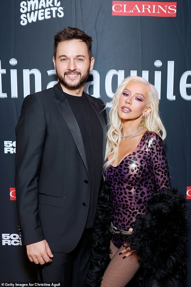 Christina, who wore her platinum blonde locks in soft waves, also posed with her fiancé Matthew Rutler at the party