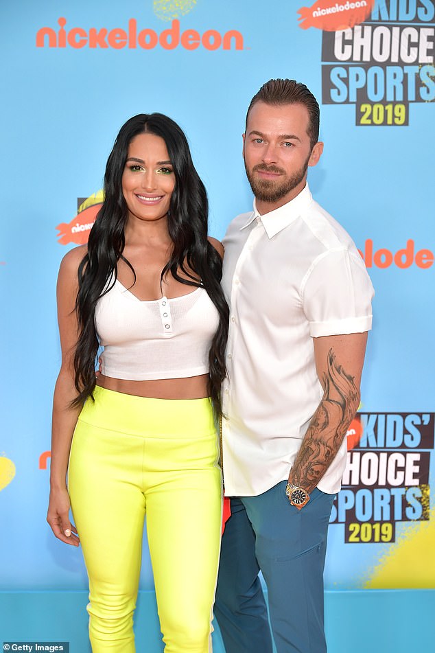 Artem Chigvintsev, 42, has updated his Instagram bio to remove the name of his wife Nikki Garcia, 40, following his arrest for domestic violence; they were seen in 2019