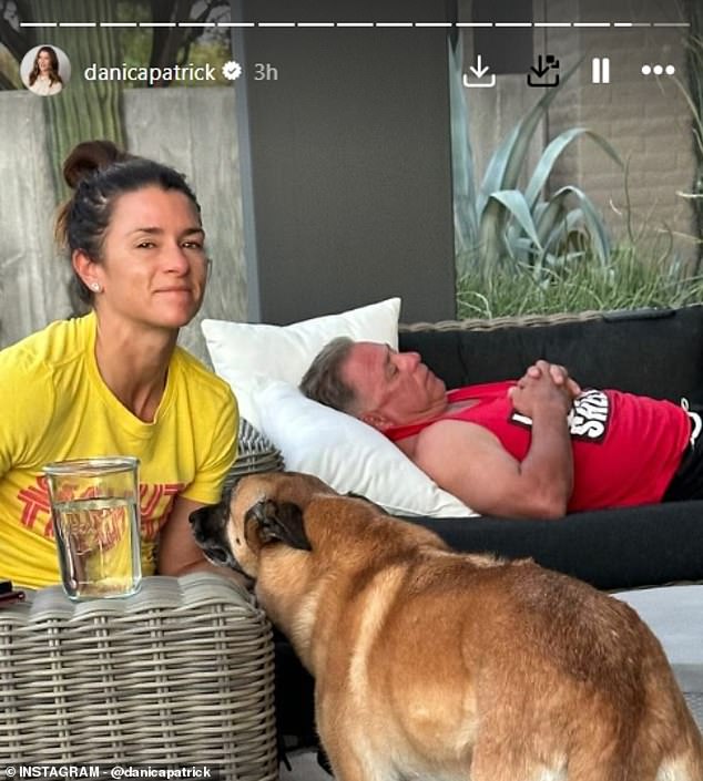 Patrick posted a photo of herself with her dog, Ella, and her sleeping father in the background