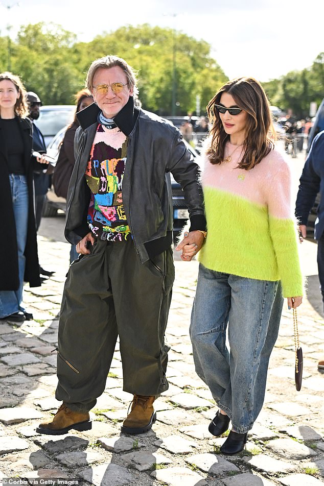 Daniel Craig turned heads in another quirky colorful ensemble as the former Bond star headed to Loewe during Paris Fashion Week with his wife Rachel Weisz on Friday