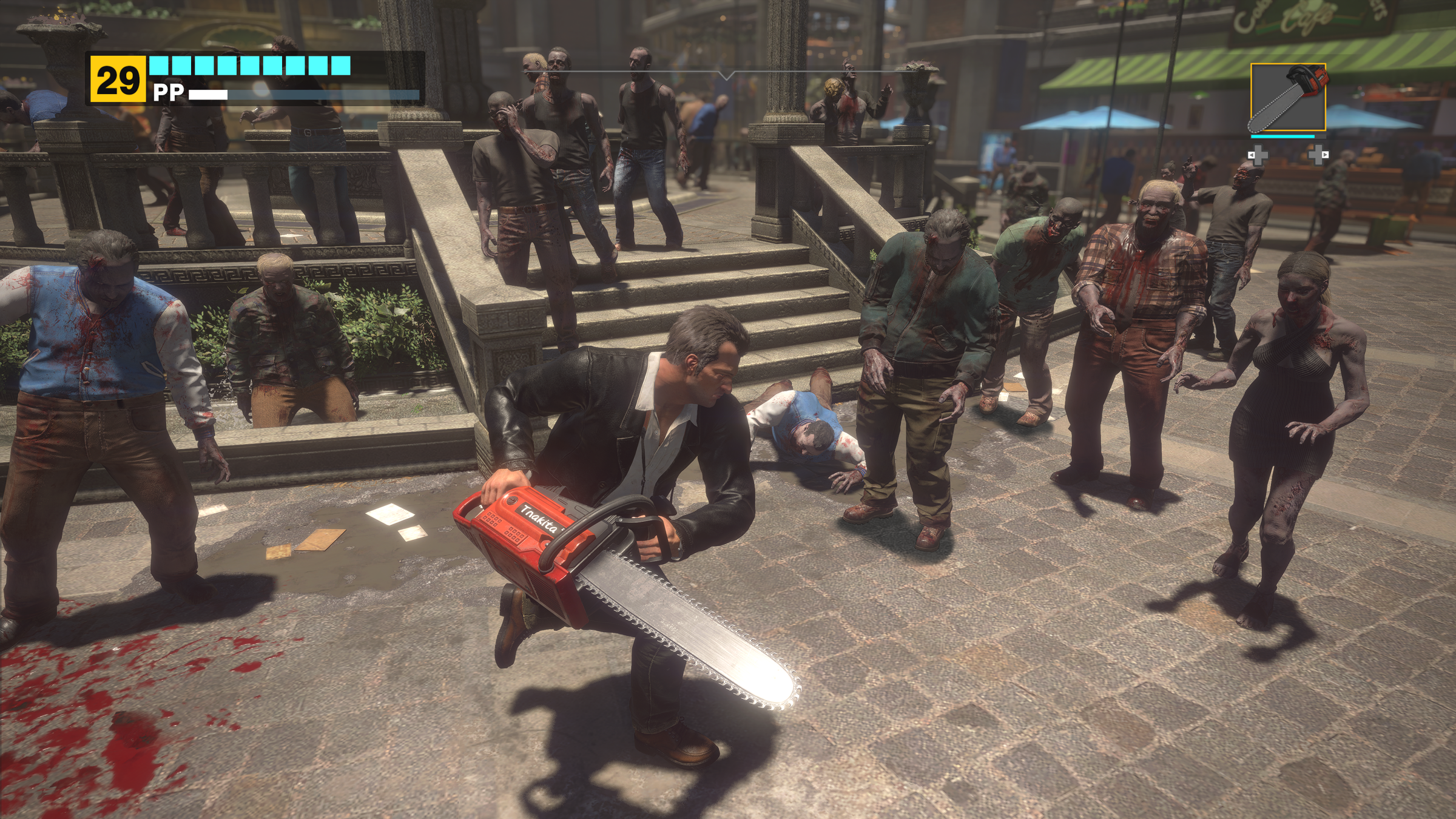 Frank West uses a chainsaw on a group of zombies in a screenshot from Dead Rising Deluxe Remaster