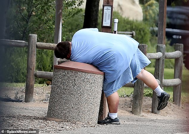 Unearthed photos of Barbara Streisand's stepson Jess Brolin show him dumpster diving in a wealthy California city more than a decade ago. The footage shows him dressed in blue and looking even bigger than he is now, grabbing food from a bin.