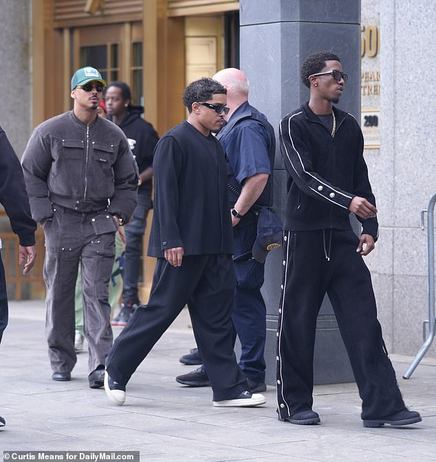 Justin (M), Christian (R) and Quincy (L) arrived together at the federal courthouse as they supported their father in court earlier this week