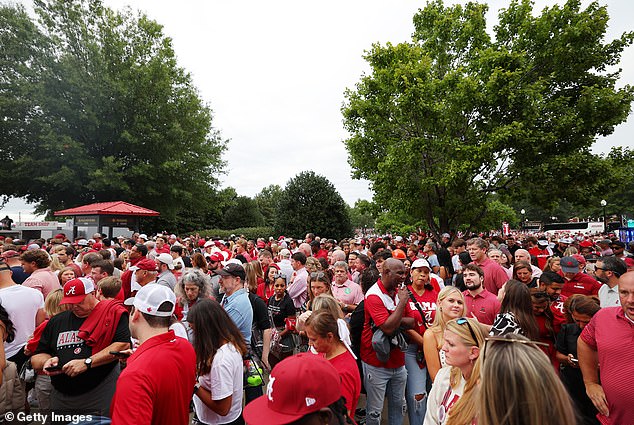 Fans wait outside Bryant-Denny Stadium as security is increased before the game