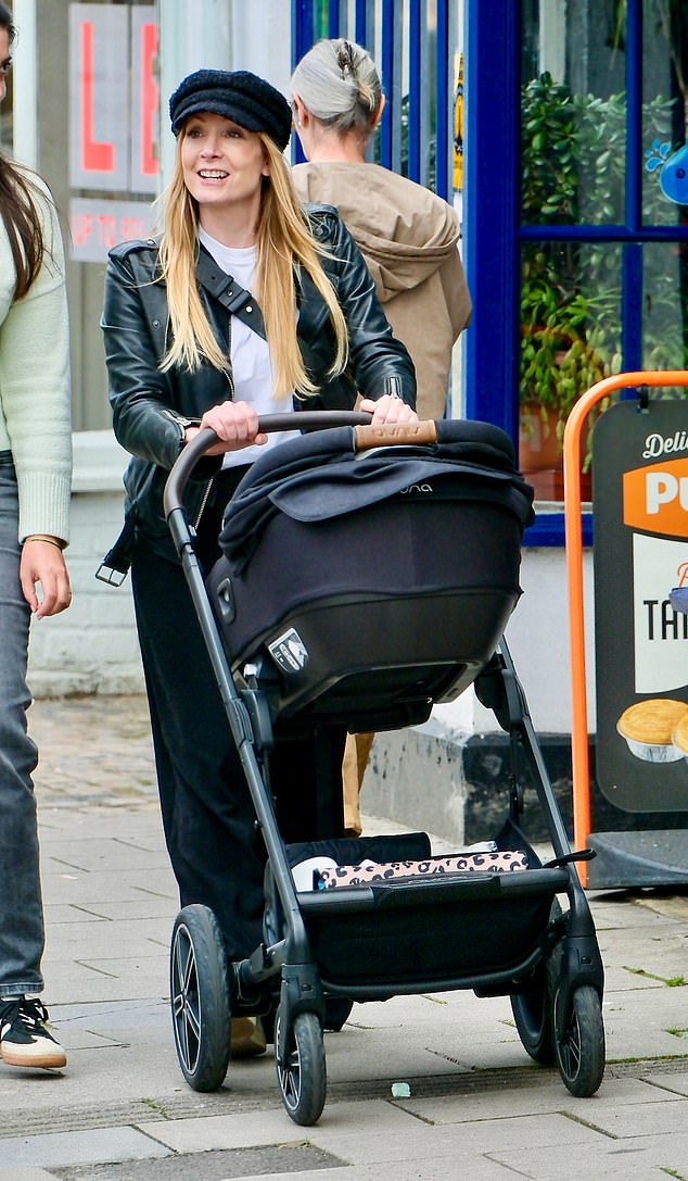 Joanne Froggatt beamed as she pushed her newborn's pram during a walk through Berkshire