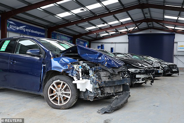 A Reuters report last year warned of a rise in the number of electric vehicles being written off due to minor damage to their batteries. Pictured: Damaged electric and hybrid cars at the Doncaster yard of British salvage company Synetiq