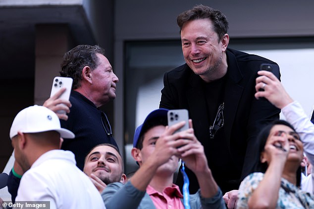 Elon Musk posed for selfies with fans as he attended the men's singles final between Taylor Fritz of the United States and Jannik Sinner of Italy yesterday