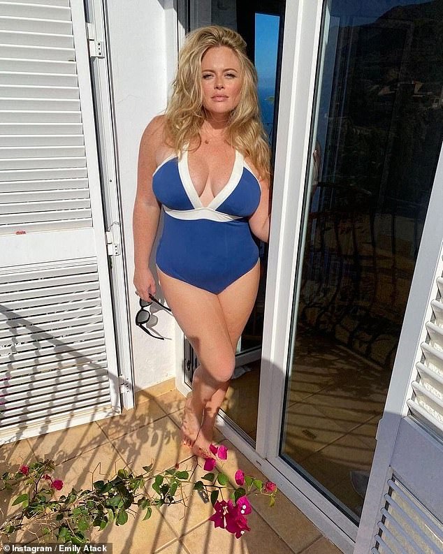 Emily Atack, 34, showed off her figure in a deep blue swimsuit on Saturday as she enjoyed a holiday with her boyfriend Alistair Garner and their two-month-old son Barney