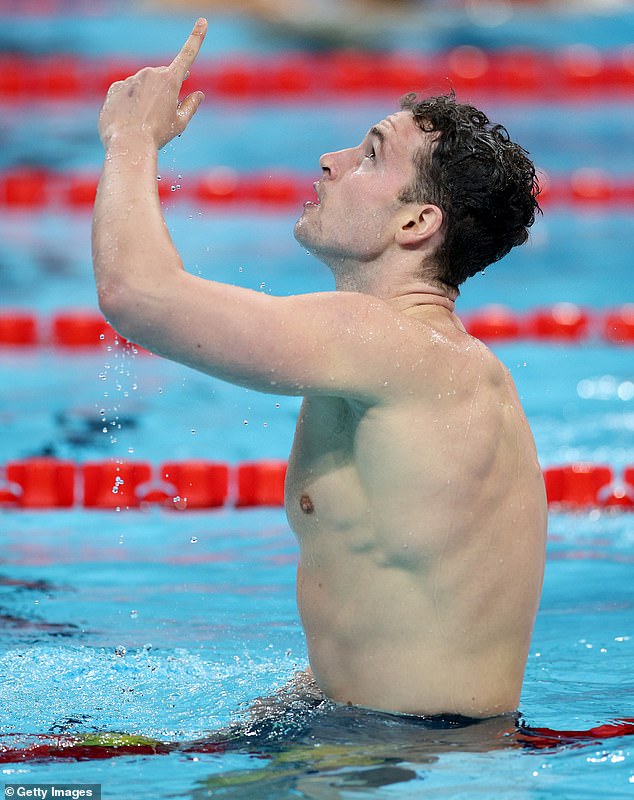 Australian Paralympic athlete Benjamin Hance points skyward to honor his late father after winning the S14 men's 100m backstroke final