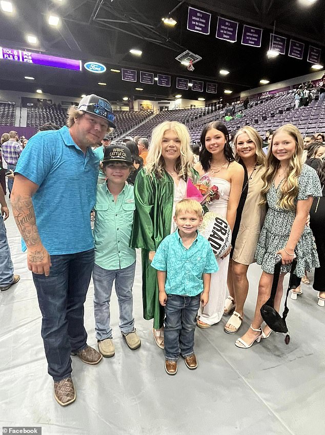 Dustin Dorcz, a father of six, is pictured with five of his children and his wife. His children range in age from 6 to 18