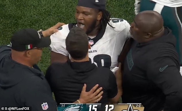 Jalen Carter was held down on the Eagles sideline while celebrating his team's victory