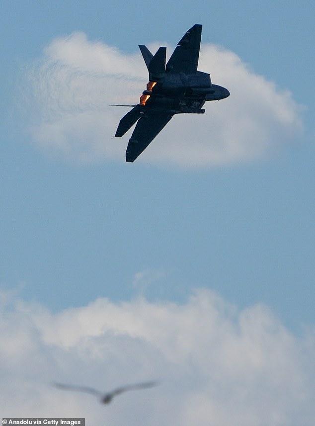 The strange photo shows what appears to be a circular white object shot down by a U.S. Air Force F-22 Raptor stealth fighter during a joint mission with the Canadian Armed Forces. Above, another USAF F-22 Raptor during an air show over Toronto, Canada on August 31, 2024