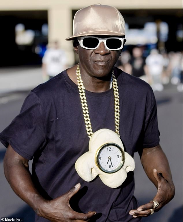 Flavor Flav showed off a new watch around his neck in Los Angeles on Tuesday. The 65-year-old rapper — real name William Jonathan Drayton Jr. — wore a large chain that resembled a piece of popcorn with a watch in the middle