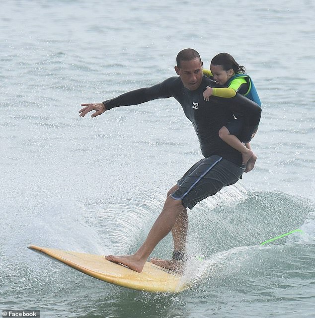 Jorge Alvarado, 49, hit a sandbar on Sept. 13 and then became entangled in a pole under the pier. PICTURED: Jorge Alvarado surfing with his son Gabriel