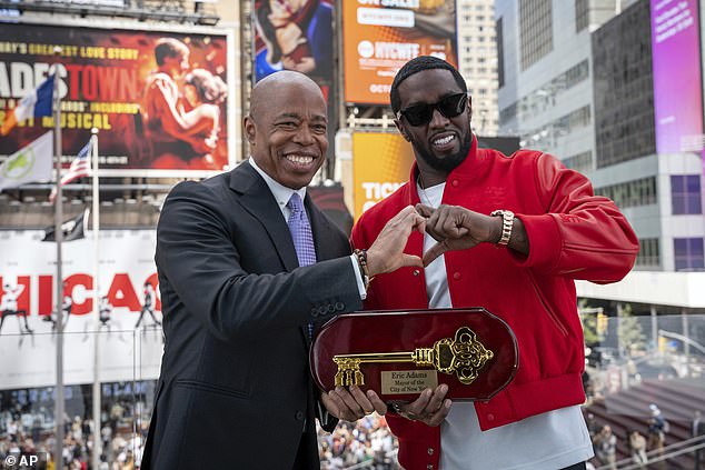 This photo, provided by the New York City Mayor's Office, shows Mayor Eric Adams (left) presenting the key to the city to hip-hop artist Sean "Diddy" Combs in Times Square in New York, Friday, September 15, 2023