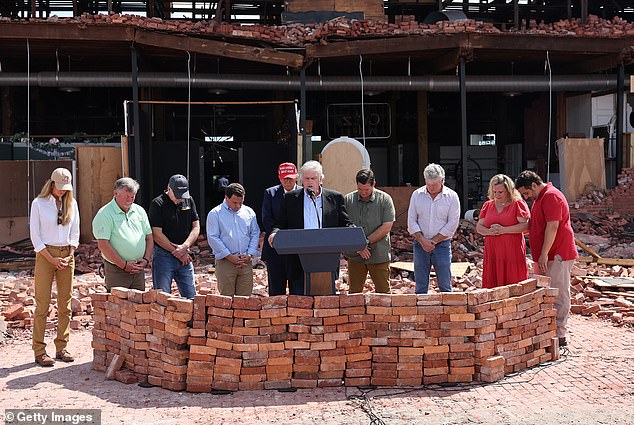 Franklin Graham, president of Samaritan's Purse, offers a prayer as he accompanies Republican presidential candidate, former U.S. President Donald Trump, during a visit to Chez What Furniture Store, which was damaged during Hurricane Helene