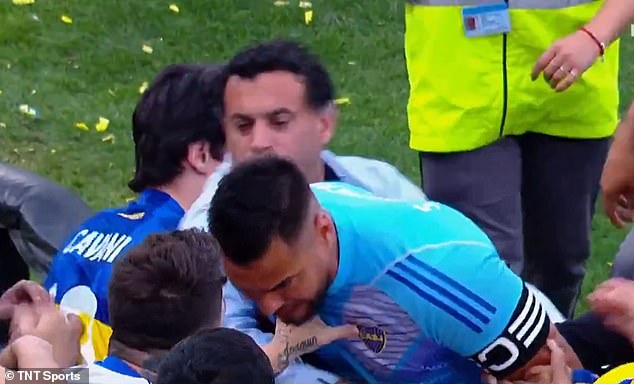 A Boca fan places his left hand on goalkeeper Romero's chest after the loss to River Plate