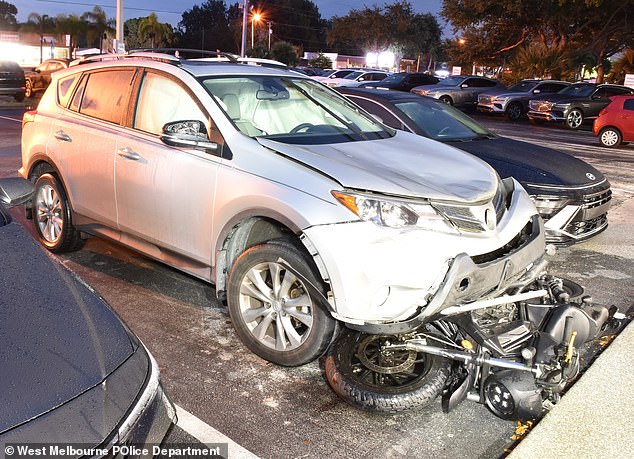 Police say this is Tate's SUV with the motorcycle tangled underneath. She left her car at a Hyundai dealership and was picked up in a sedan, according to court documents.