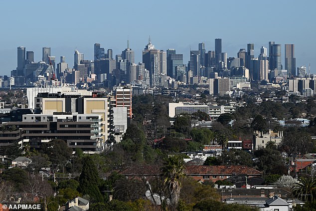 Australian homeowners have faced 13 interest rate hikes since May 2022. Pictured is Melbourne's CBD seen from a new housing development