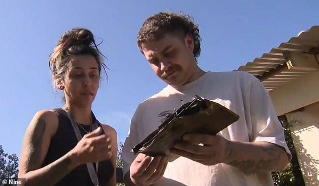 Perth couple Jarrod and Java lost their home after a charging iPad caused a horrific house fire (the couple are pictured with the damaged Apple device)