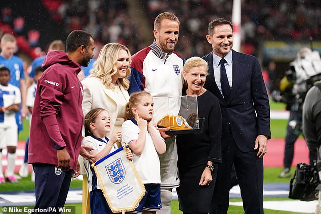 Kane, his wife Kate and children were presented with a gold England cap before the match on Tuesday