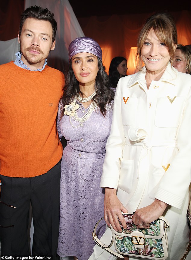 Harry Styles made sure he didn't miss the action at Paris Fashion Week as he arrived in the French capital for one of the final shows on Sunday (L-R: Harry Styles, Salma Hayek and Carla Bruni)