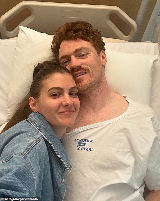 Veteran Geelong forward Gary Rohan (pictured with wife Madi Rohan) is in hospital awaiting treatment for a fractured skull suffered during a VFL match on Saturday.