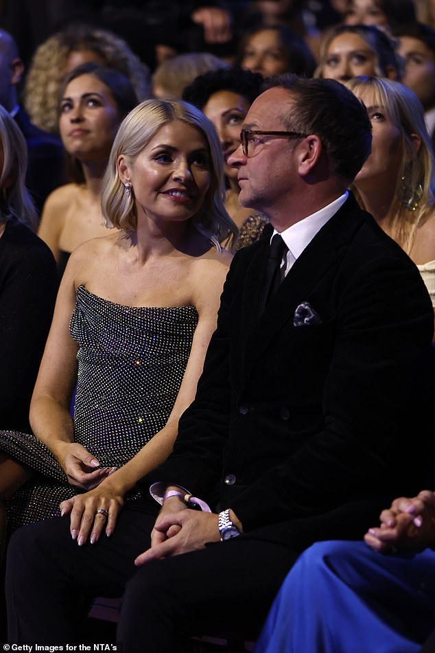 Holly Willoughby was spotted putting on a loving show with her husband Dan Baldwin as they sat in the audience at the National Television Awards on Wednesday