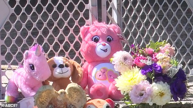 The deaths have shocked the community and a large number of flowers and teddy bears have been laid at the family's home