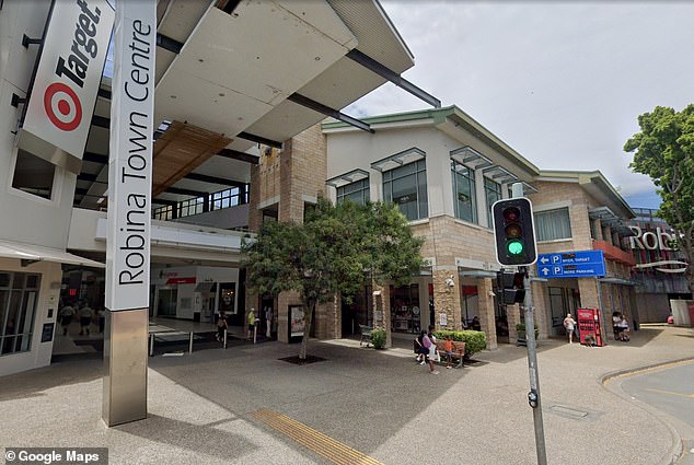 Paramedics treat a bus driver for a stab wound to the hip after he was attacked by a young man at Robina Town Centre shortly before 1pm (pictured).