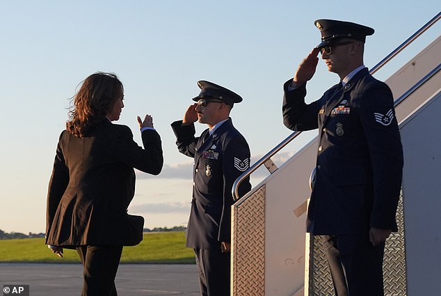 Kamala Harris salutes as she boards Air Force 2