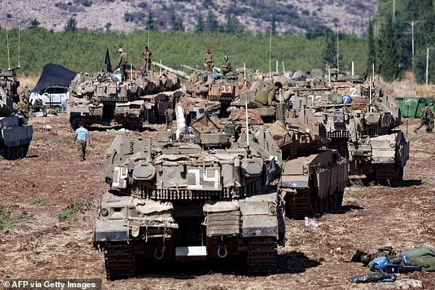 Hundreds of Israeli tanks have lined up on the border with Lebanon, with a ground invasion looming