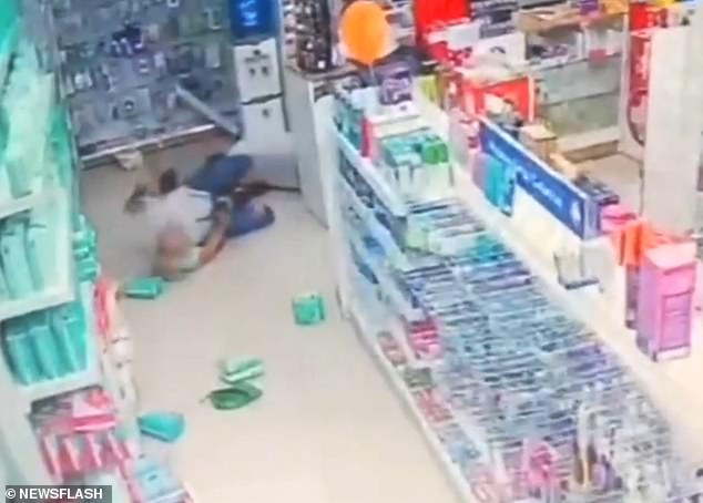 The clerk pushed one of the robbers to the ground and hit him several times on the head