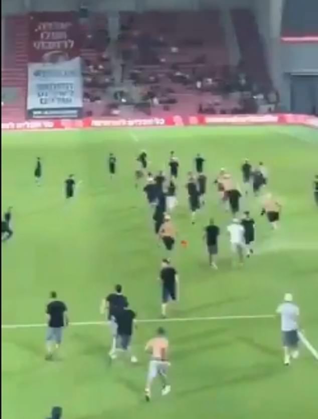 When Hapoel Beersheba fans saw their rivals turn away from the Israeli national anthem, they ran onto the pitch to confront them, provoking violent clashes