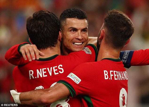 Ronaldo celebrates with teammates after scoring a late winner for Portugal against the Scots